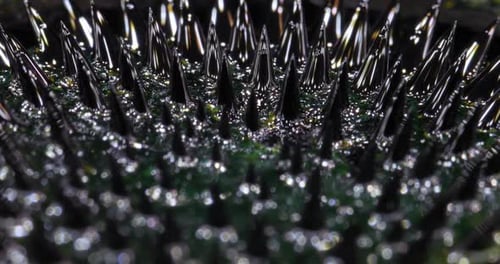 Ferrofluid Tinted with Colored Paints Yellow Green The Surface of the Black Liquid Abstract