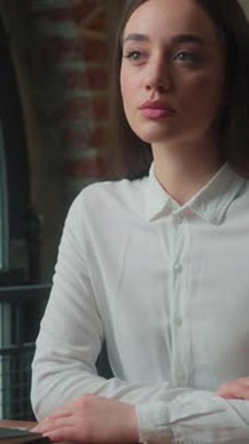 Serious Pensive Confident Caucasian Business Woman Girl Female Sitting at Table in Office Workplace