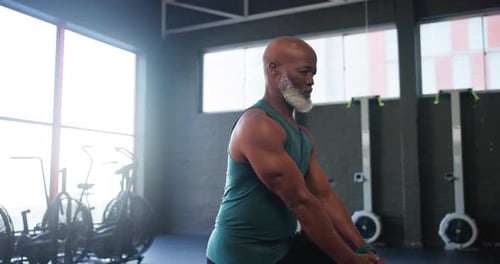 Fitness, senior man and stretching leg in gym for exercise warm up, retirement wellness