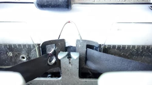 Close up shot on mechanical typewriter, white paper. Journalistic theme.