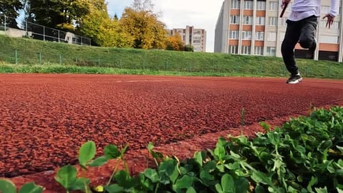 Close-up of a Person Running on Athletics track. Shot from the Bottom. Sports, Athletics