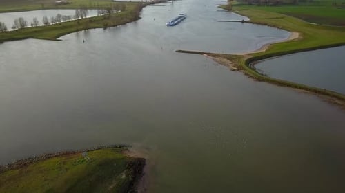 panning up to see the big boat crossing the canal or lake in Holland in 4K and 30 FPS