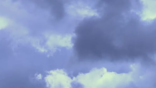 Clouds Drifting Slowly in a Pale Blue Sky