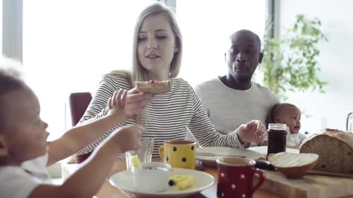 Happy Family Enjoying Breakfast Together at Home
