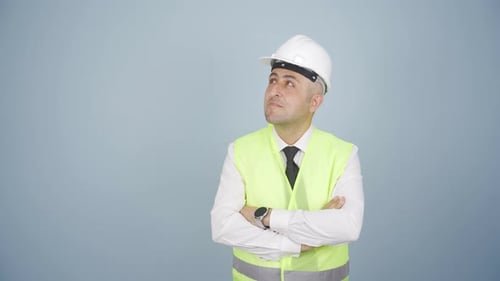The engineer watching the construction is thoughtful.