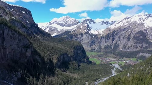 Drone flight over a beautiful alpine glacier valley and vast mountainous landscape. Kandersteg, Swit