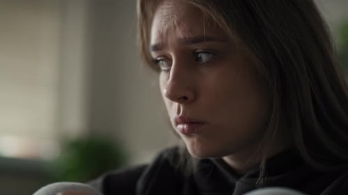 Caucasian woman with huge stress sitting at home. Shot with RED helium camera in 8K.