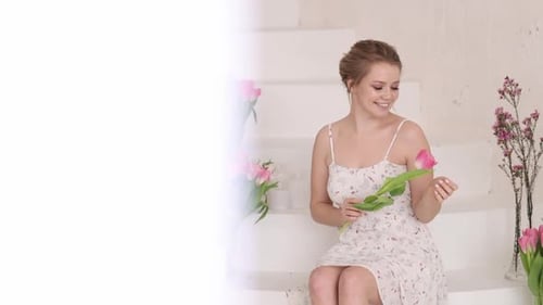 Smiling Woman Holds Pink Tulip on Stairs