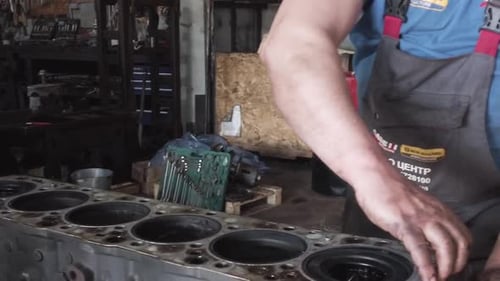 Mechanic Assembling Engine in Auto Repair Shop