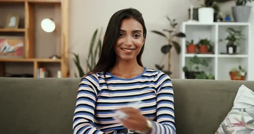 Face, smile and woman in lounge, relax and comfortable on break in condo