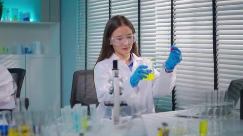 Asian female scientist working in biotechnology research laboratory.