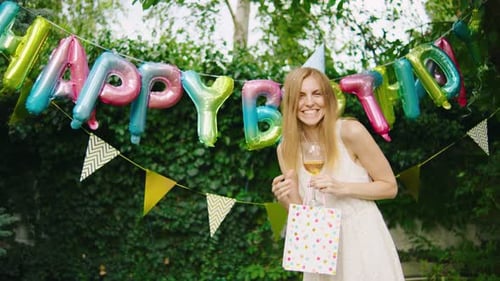 Happy Young Woman Celebrates Birthday Outdoors