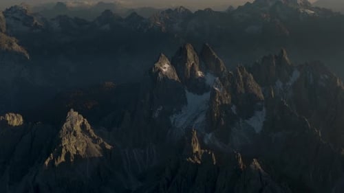 Cinematic Drone Flight Over Majestic Jagged Mountain Peaks At Sunset