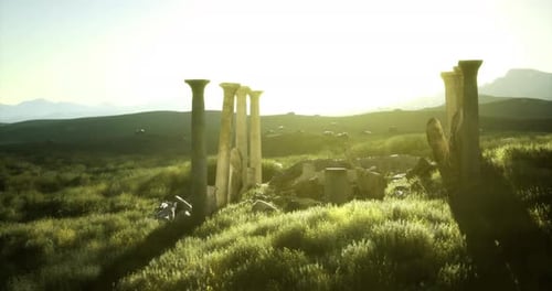 Ancient Ruins Stand in the Sunlit Field Surrounded By Green Landscape