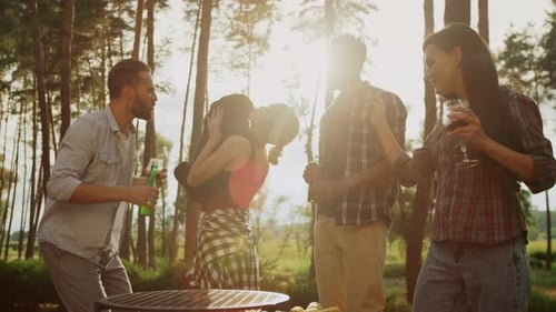 Friends Celebrate with Drinks and Grill Outdoors
