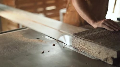 Close up of Woodworker Cutting Lumber on Table Saw