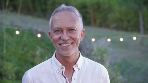 Smiling Man Standing Outside in Nature