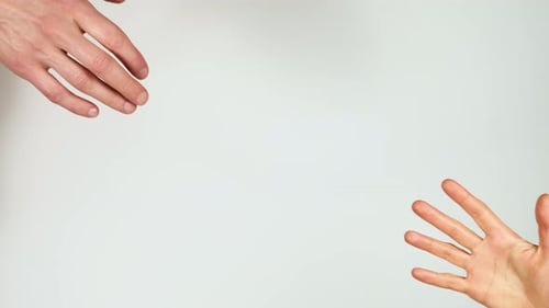 Hands Reaching and Connecting Against White Background