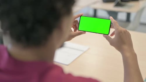 Close Up of African Man Watching Smartphone with Green Screen