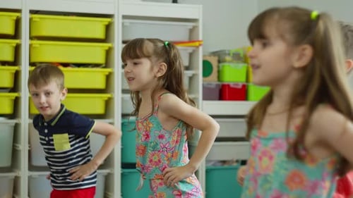 Children Learning and Clapping in a Bright Classroom