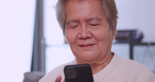 Senior Adult Using Mobile Phone Indoors