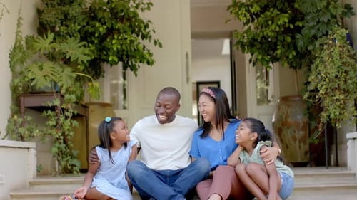 Happy Family Sitting Together on Porch Steps