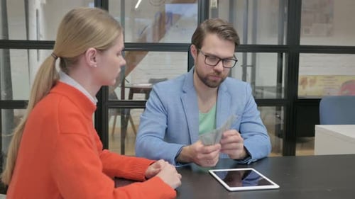 Male Customer Paying Money to Businesswoman