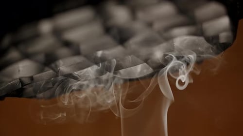 White smoke rises up is drawn into the cooker hood, smoke removal process