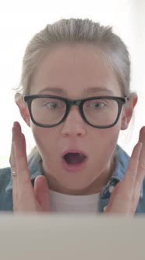Close up of Young Woman Reacting to Loss on Laptop, Vertical Video