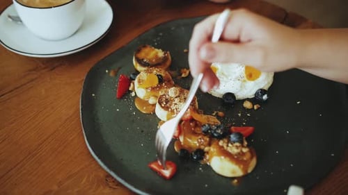 Eating Pancakes with Caramel and Blueberries at Brunch