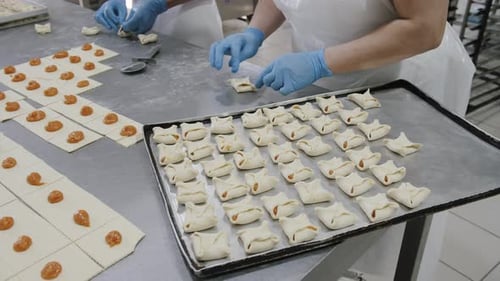 Making a Puff Pastry with Apricot Jam in the Bakery Shop