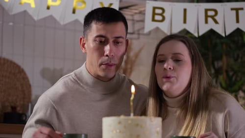 Couple Celebrating a Birthday Together with Cake and Coffee