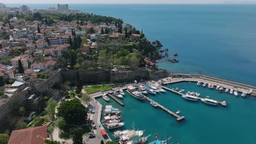 Forwards Fly Above Boats Moored in City Marina Aerial View of Old Town District Near Mediterranean