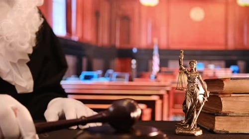 In a Courtroom with a Gavel Lady Justice Law Books Lawyers and a Judge Ensure Fairness