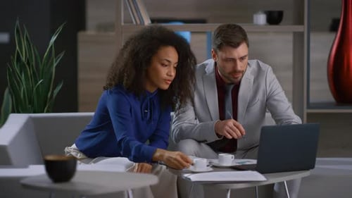 Multiethnic Corporate Couple Working Laptop Computer in Cafe Office. Diverse Business Team