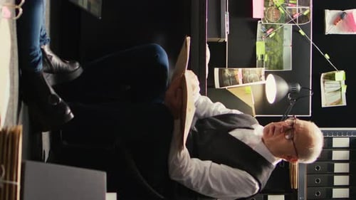 Man Reviewing Documents at Office Desk