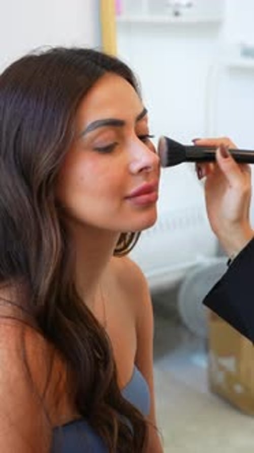 Woman Getting Makeup Applied with Brush in Home