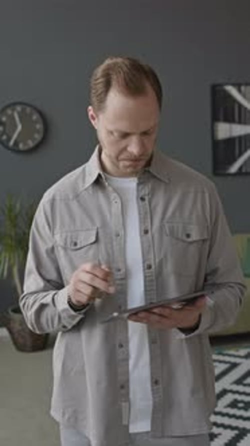 Young Man Using Digital Tablet in Office
