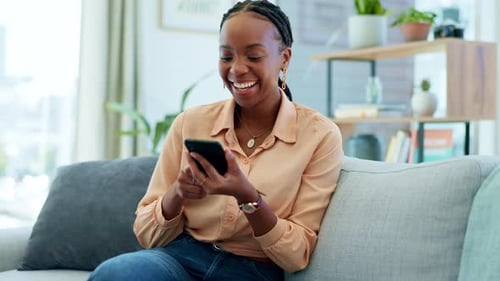Woman Using Smartphone Relaxing on Gray Couch