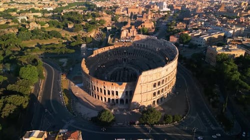 Drone Flying Away from the Colosseum. Famous Ancient Roman Arena. Downtown Rome, Italy