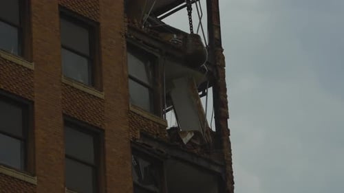 A close-up view of the demolition of a high-rise building in Youngstown, Ohio, showing significant s