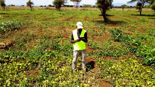 Rural agricultural farms in Kenya. Drone pilot land survey. Smart Agriculture technology.