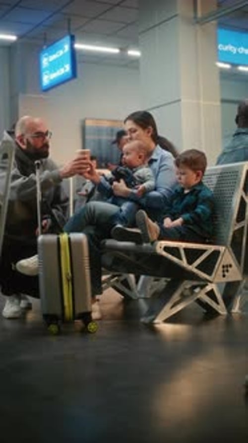 Boarding Lounge of Airline Hub Woman with Two Little Children Waiting for Airplane Flight