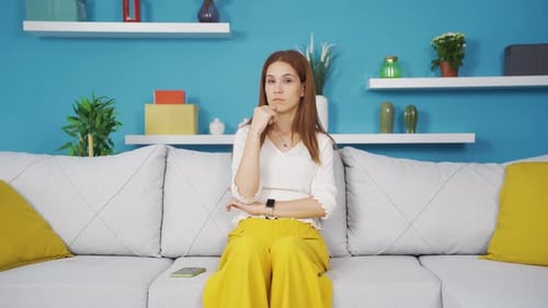 Woman Thinking Carefully on Couch Indoors