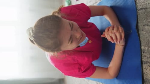 Woman Doing Plank Exercises on Blue Exercise Mat