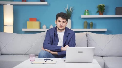 Man looking thoughtfully at camera.