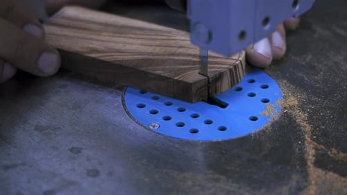 Craftsman Using Band Saw to Cut Wood