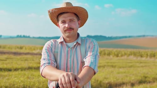 Close Up of Adult Farmer Holding Shovel His Hands and Looking Closely While Enjoying of His Work