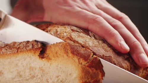 Fresh Bread Being Sliced with Knife