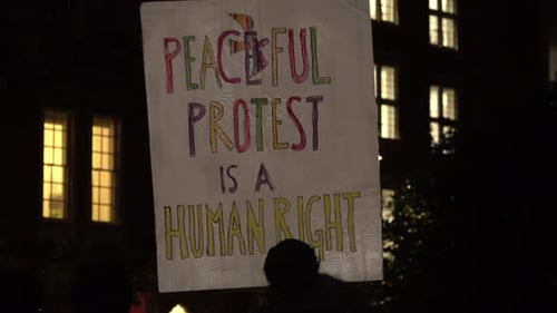 Protest Sign Held at Peaceful Demonstration at Night